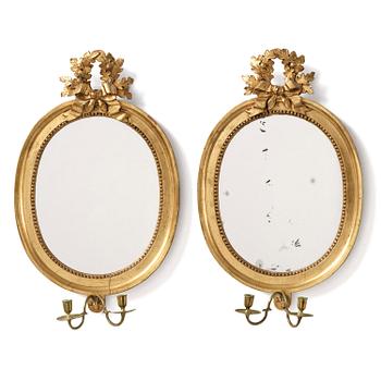 121. A pair of Gustavian giltwood two-branch girandole mirrors by J. Åkerblad (master in Stockholm 1758-99).