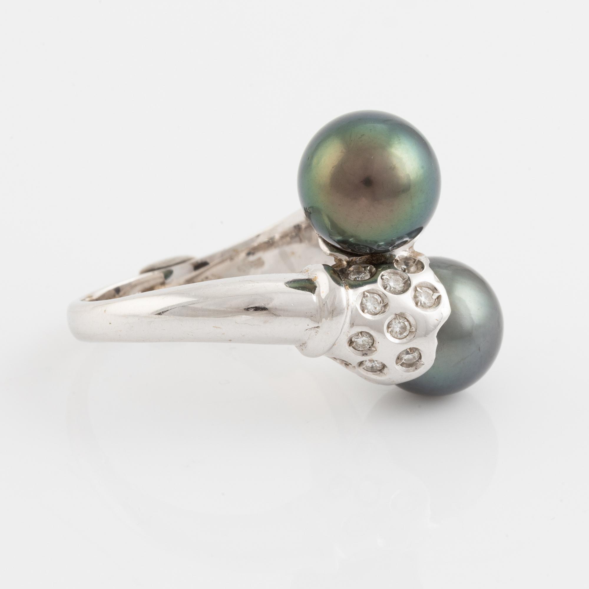 Cultured black pearl and brilliant cut diamond cross over ring.