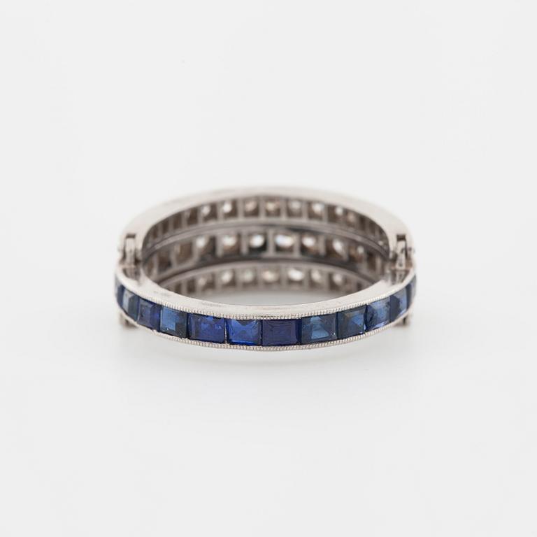A square cut sapphire and single cut diamond ring.
