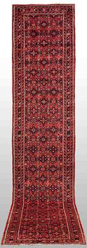 A Hosseinabad carpet, c. 430 x 90 cm.