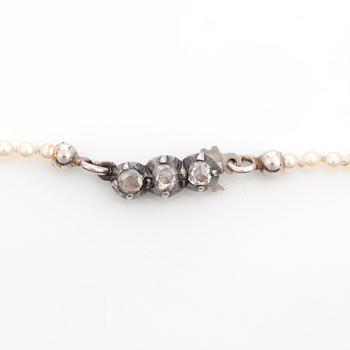 A graduated single strand, slightly baroque, possibly natural pearl necklace.