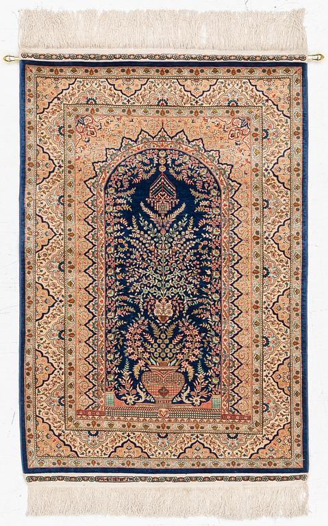 A semi-antique silk Hereke rug, West Anatolia, signed c. 107 x 72 cm.