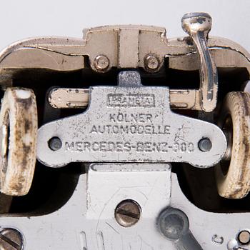 Two mid-20th century toy cars, chromed metal and wood.