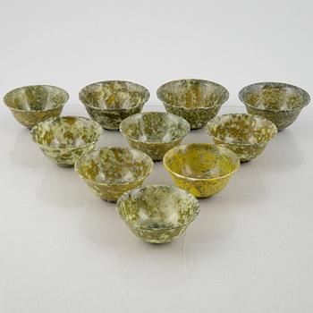 A group of ten Chinese spinach green stone bowls.