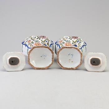 A pair of faience lidded urns, 18th/19th century.