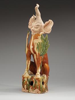 A gren and yellow glazed figure of a spirit, Tang dynasty (608- 907).