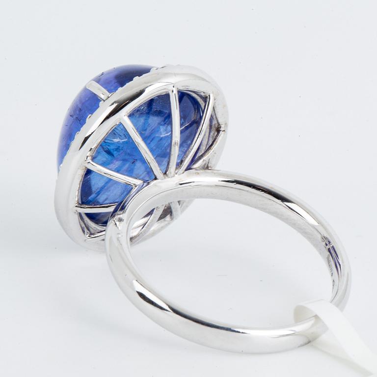 Cabochon-cut tanzanite and brilliant-cut diamond cocktail ring.