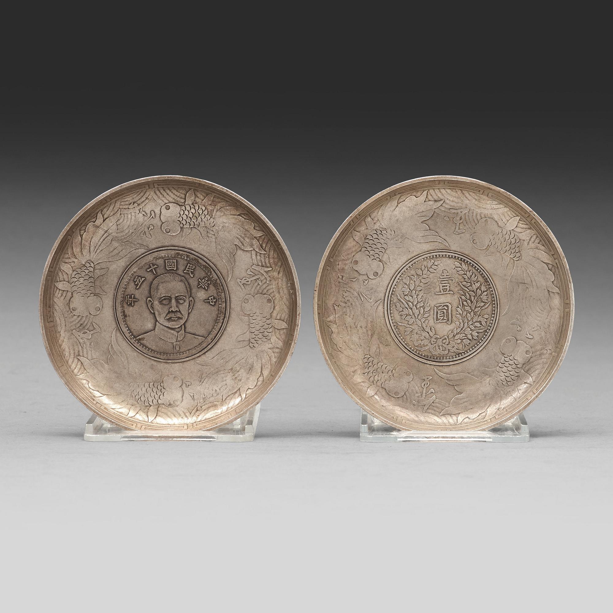 A set of two coasters with Chinese silver coins, 20th Century.
