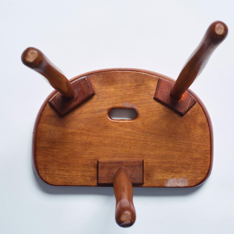 Josef Frank, a three legged mahogany stool, model 336, Svenskt Tenn, Sweden 1940-1950s.
