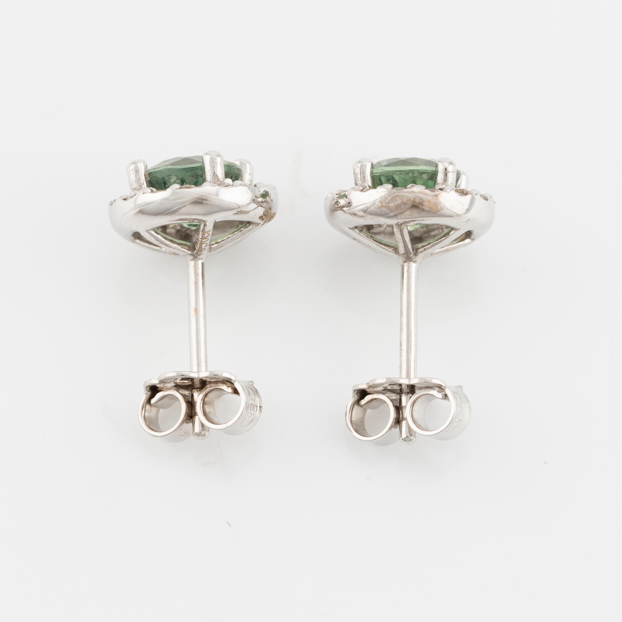 A pair of 18K gold earrings with green faceted sapphires and round brilliant-cut diamonds.