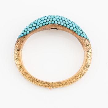 An 18K gold bracelet with turquoises and an old-cut diamond.