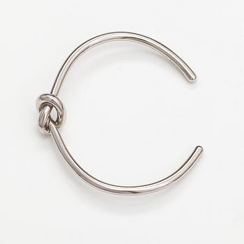 Céline, A "Knot" bracelet made of silver coloured metal. Marked Celine, C3 UCA0119 Made in Italy.