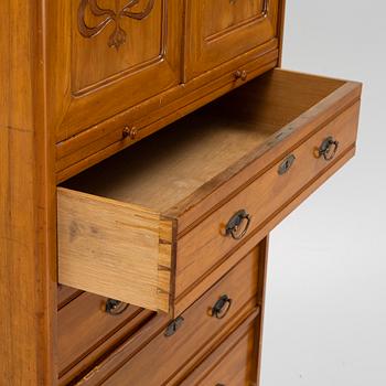 A walnut veneered tall boy dresser, early 20th century.