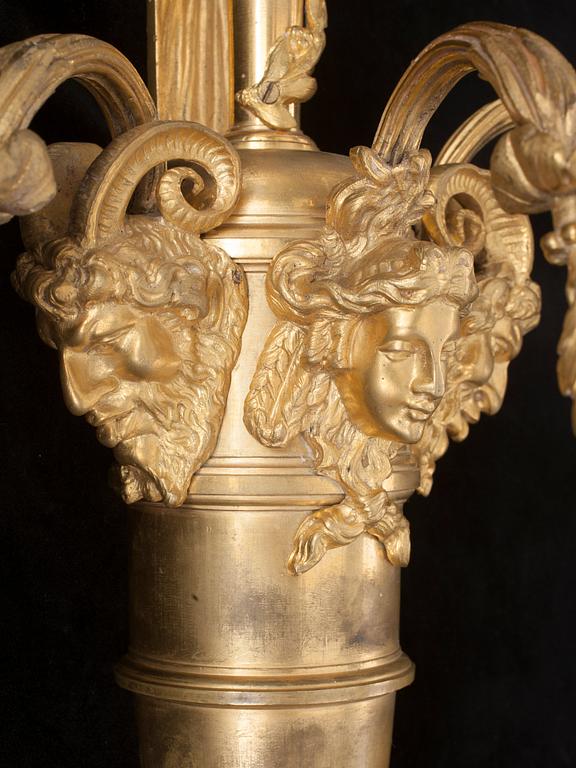 A pair of Louis XVI-style 19th century gilt bronze three-light wall-lights.