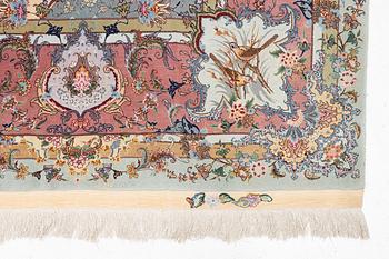 A Tabriz carpet, part silk, approx. 367 x 250 cm.