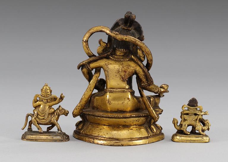 A set of three gilt bronze figures, one of Kuwera and two of Buddha, Qing dynasty, 18th/19th Century.