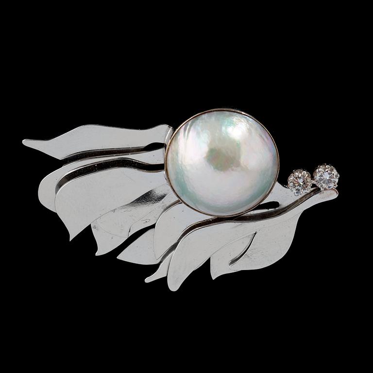 A half pearl, circa 18 mm, and diamond, circa 0.40 ct, brooch.