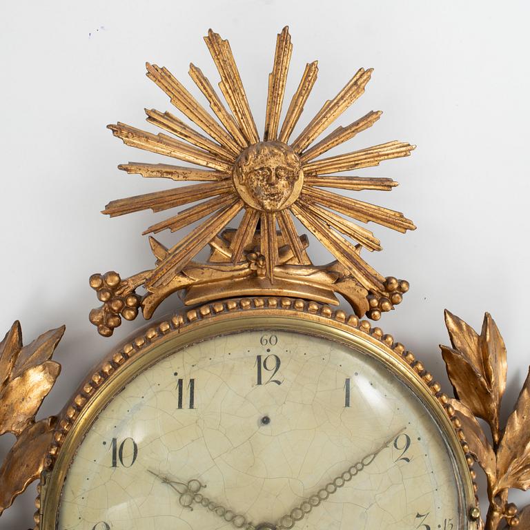 A late Gustavian carved and giltwood cartel clock by J. Kock (royal watchmaker, active 1762-1803).