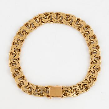An 18K gold bracelet.