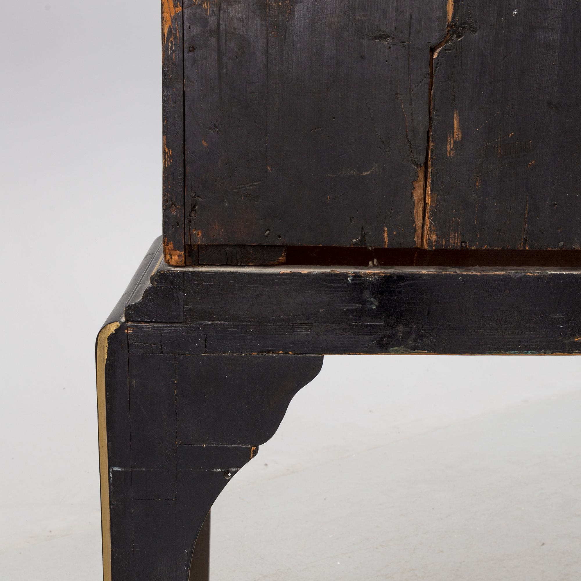AN early 18TH CENTURY PROBABLY ENGLISH Japanned laquer cabinet on stand.