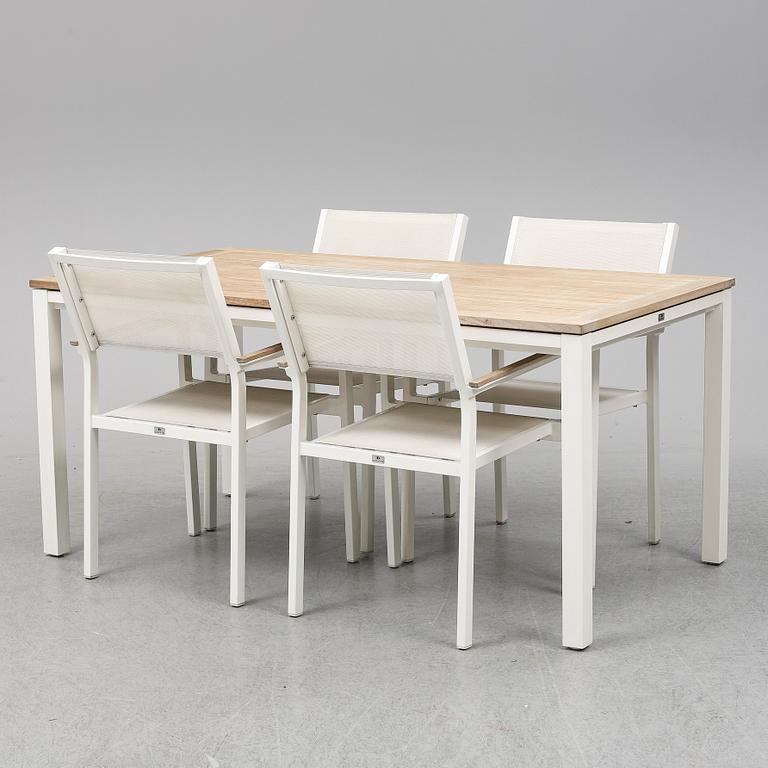 A garden table with four chairs, Gloster.