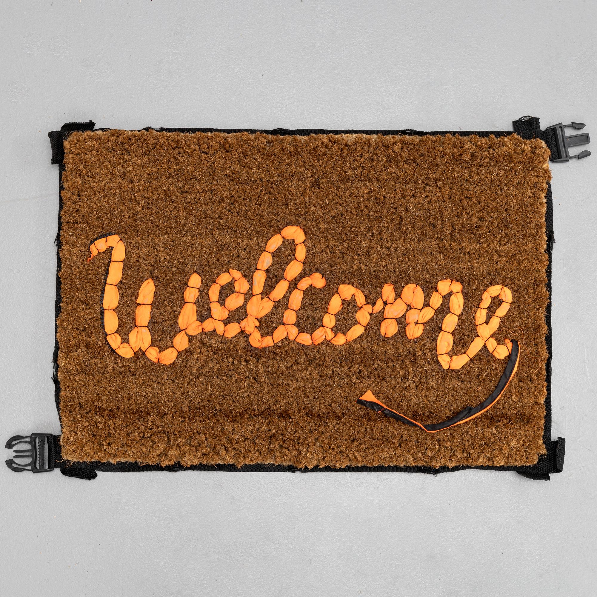 Banksy, "Welcome", Hand-stitched doormat using the fabric from life vests, 2019.