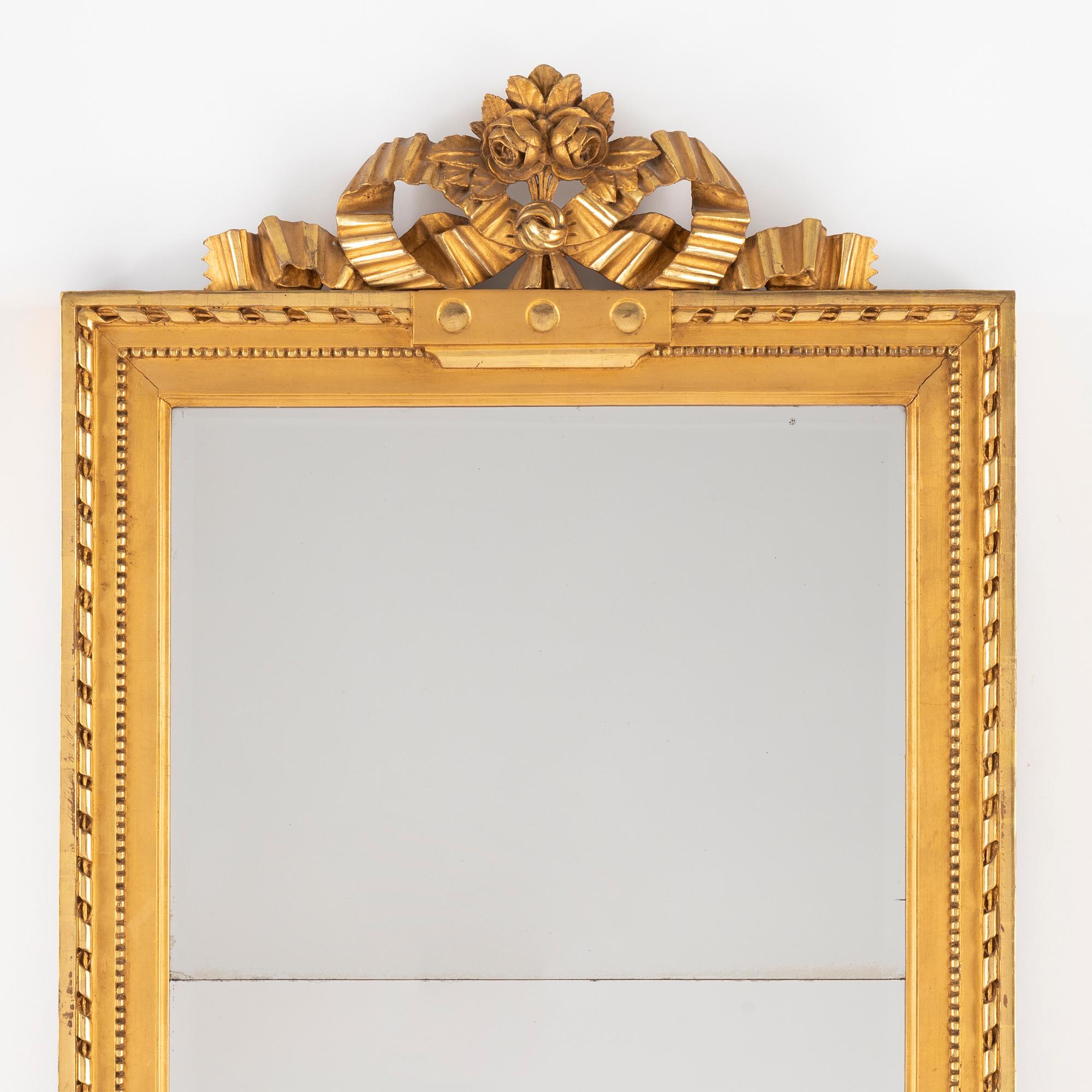 A giltwood and parcel-gilt gustavian mirror by J. Åkerblad (Master in Stockholm 1758-1799).