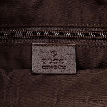 Gucci, a monogram canvas messenger bag.