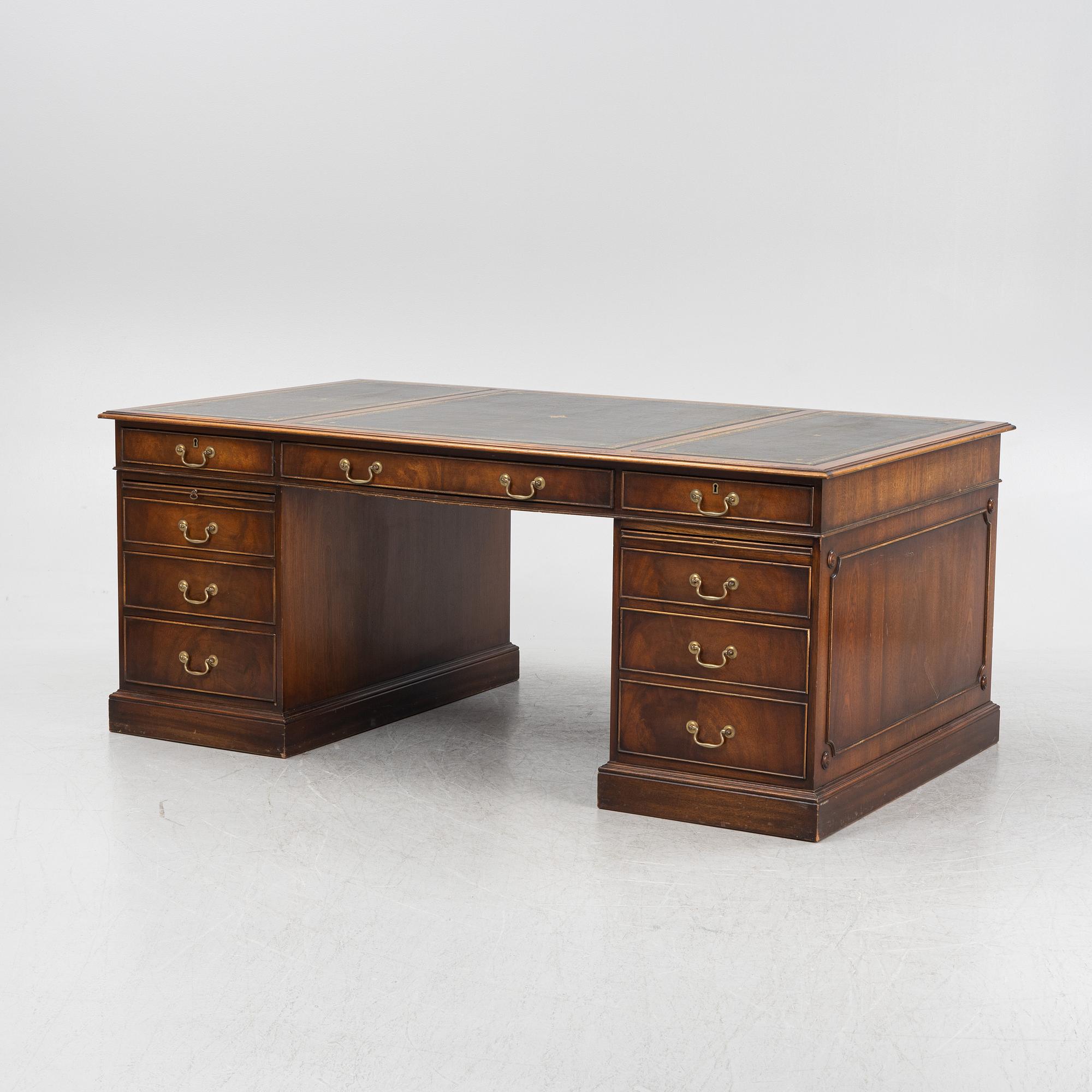 A mahogany desk, Reprodux, England, second half of the 20th Century.