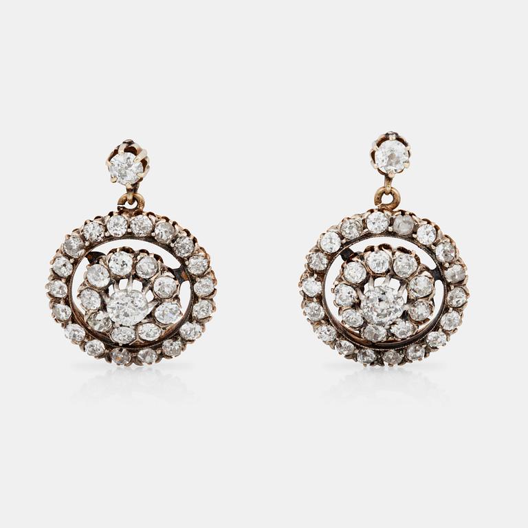 A pair of earrings set with old-cut diamonds.