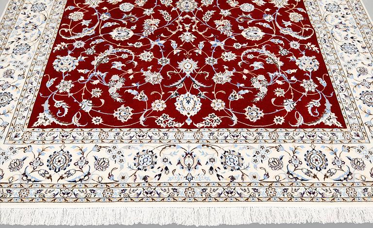 A Nain part silk carpet, 302 x 204 cm.