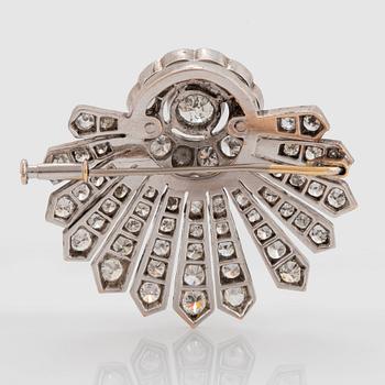 A 14K gold brooch set with round brilliant- and old-cut diamonds.