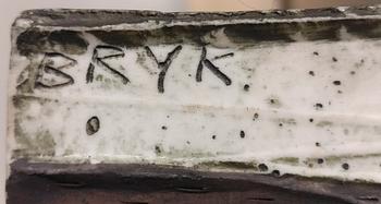 A "Rosegarland" ceramic relief signed Bryk.