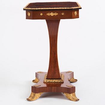 A north european Empire  'Umdruck'-decorated mahogny and gilded metal table.