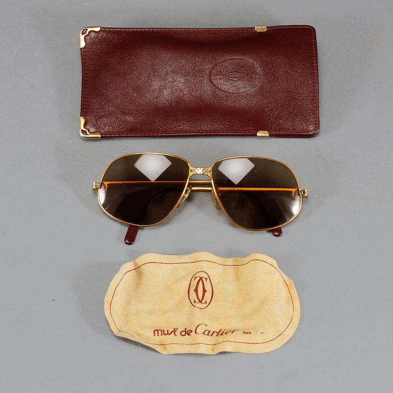 SOLGLASÖGON, Cartier.