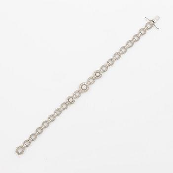 Bracelet in platinum set with round brilliant, octagonal, and rose-cut diamonds.