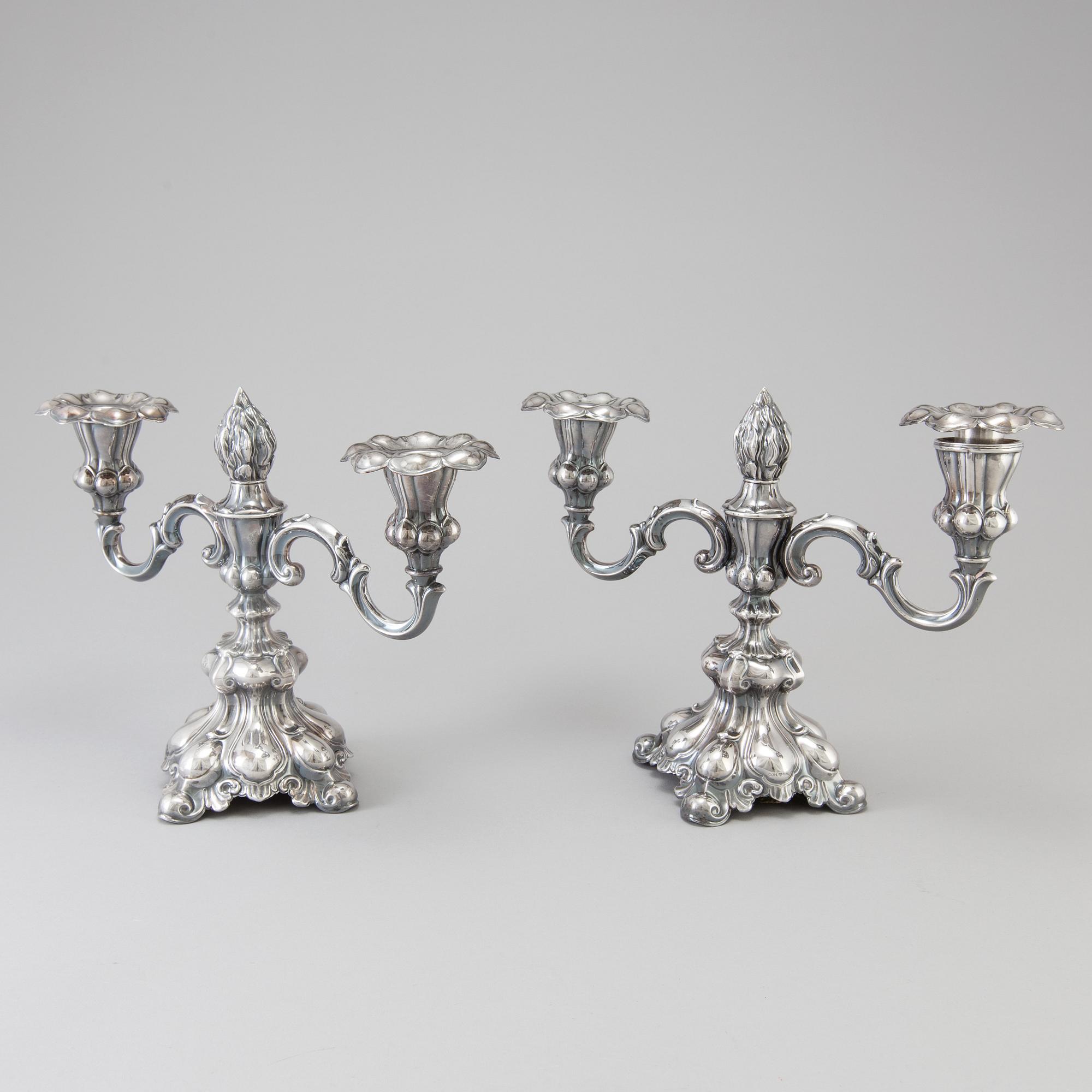 A pair of Swedish Rococo style silver candelabras from C G Hallberg in Stockholm 1955 and 1959.