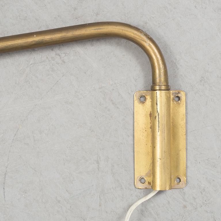 A 20th century brass and painted metal swing-arm wall light.