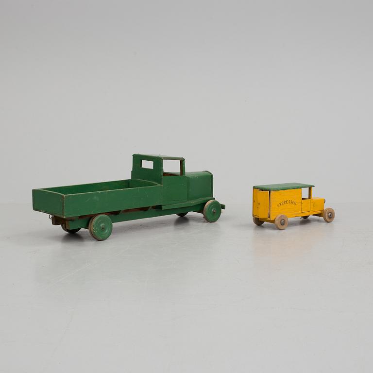 A set of two wooden toy trucks.