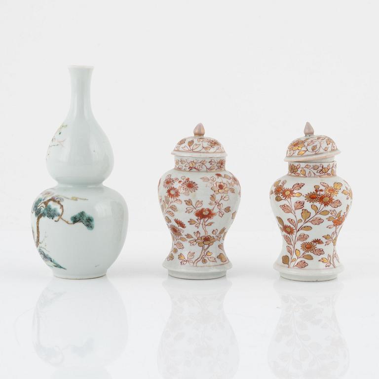 A pair of Kangxi urns, China, early 18th century, and a gourd-shaped vase, China, late 19th century.