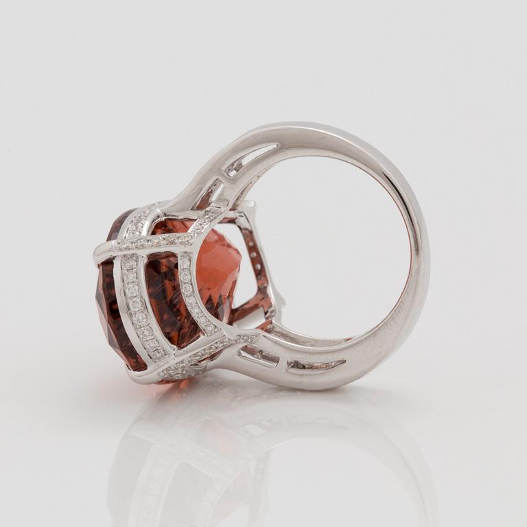 A circa 30.40 ct orange tourmaline and diamond ring. Total carat weight of diamonds circa 1.25 cts.