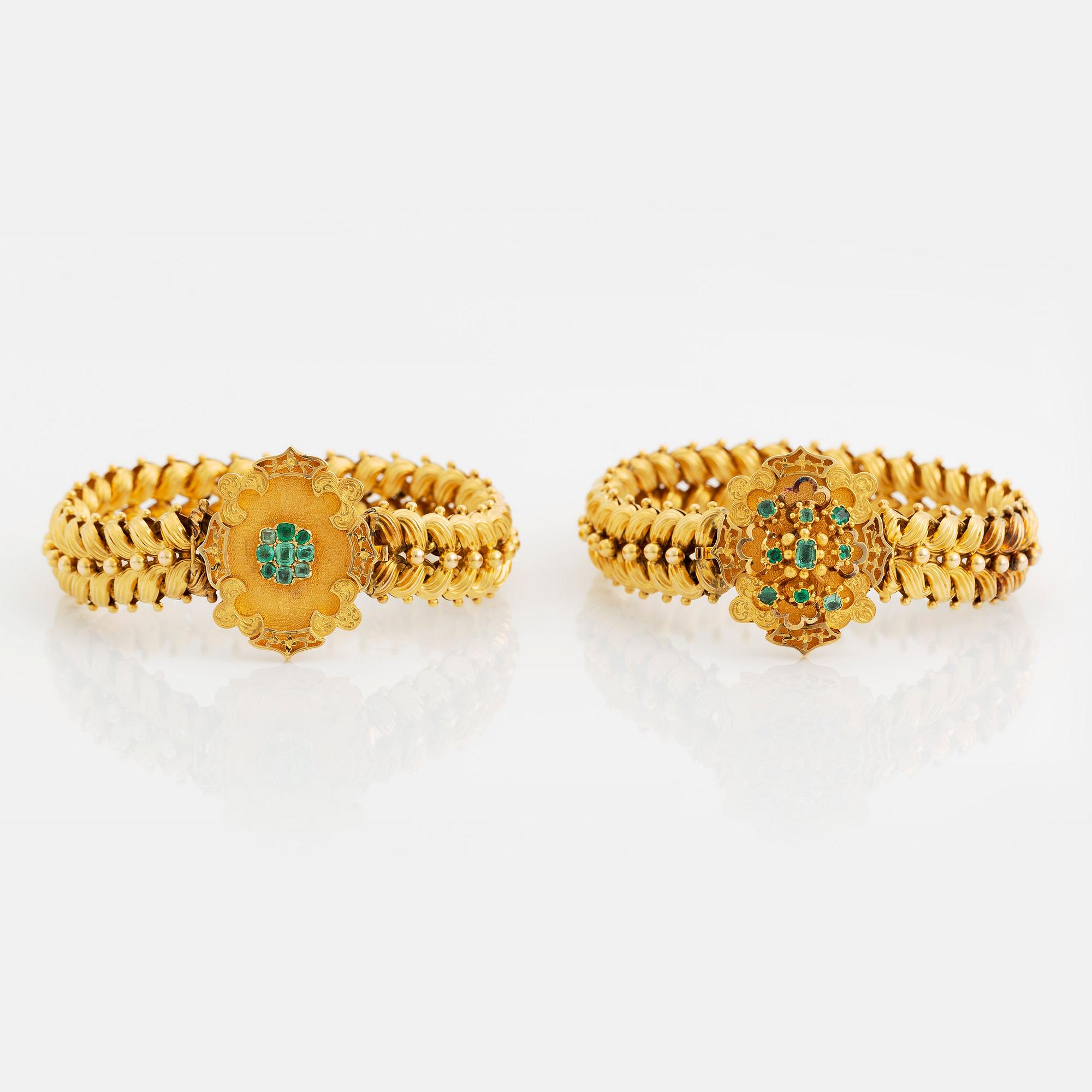 A bracelet/necklace combination in 14K gold set with faceted emeralds.