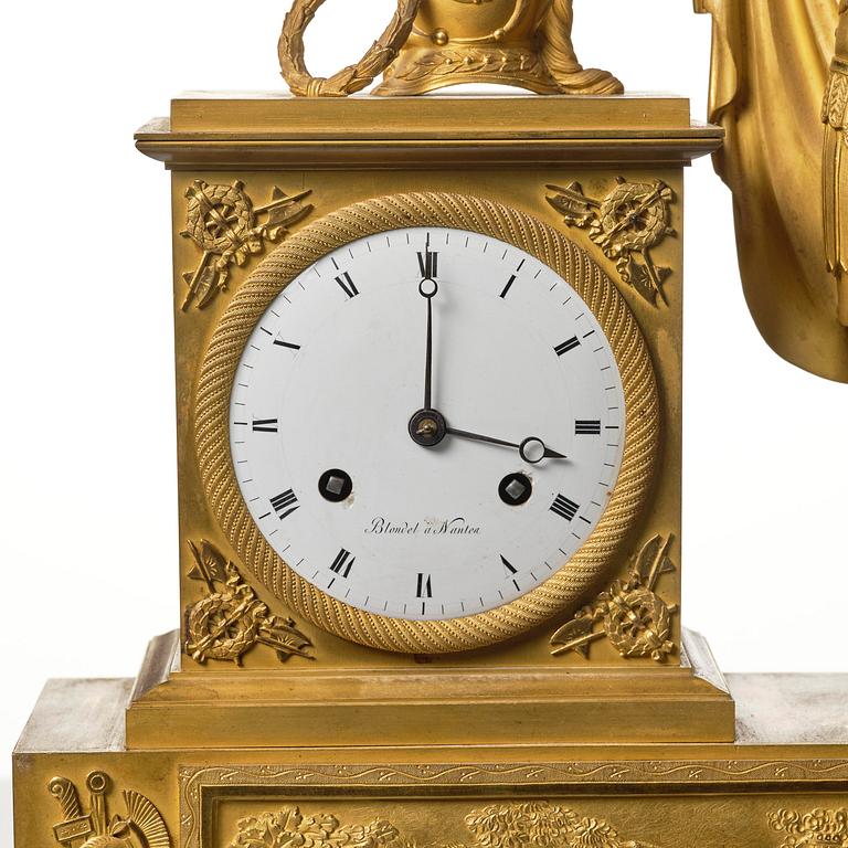 A French Empire figural ormolu mantel clock, early 19th century.