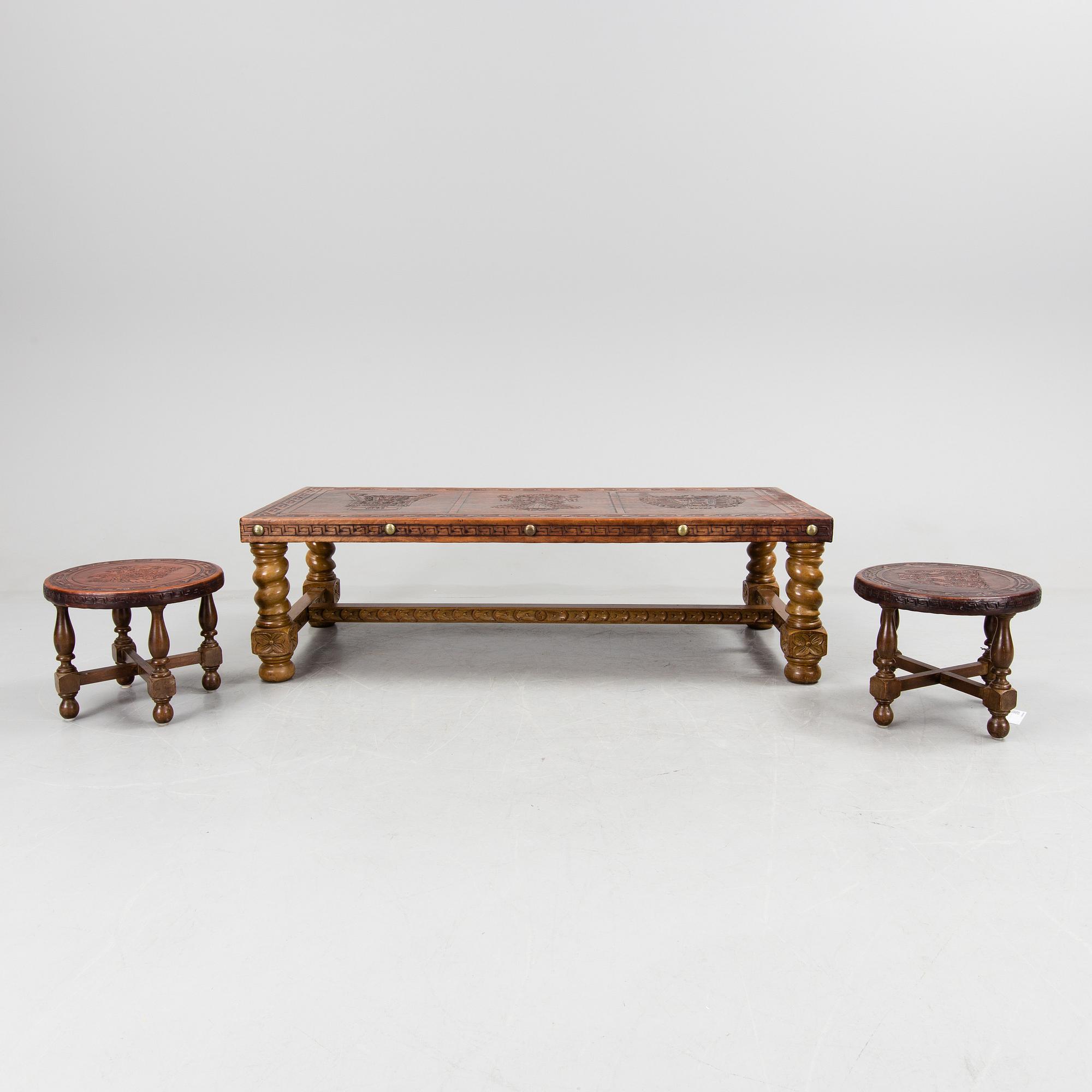 A Peruvian leather covered coffee table and pair of stools, second half of the 20th Century.
