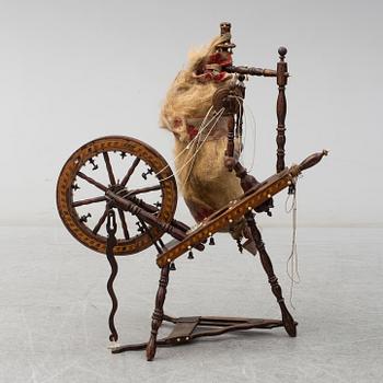 A 19th century spinning wheel.