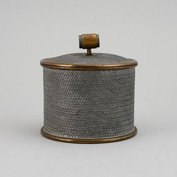 a pewter and brass jar with cover by Svenskt Tenn, Stockholm 1936.