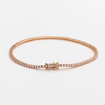 An 18K rose gold tennis bracelet with brilliant cut diamonds.
