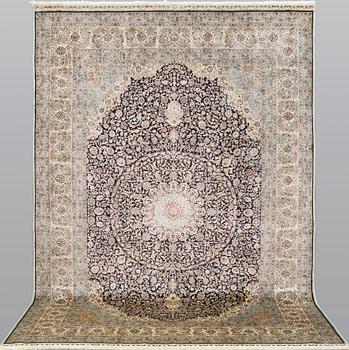 An oriental silk carpet, c. 297 x 202 cm.