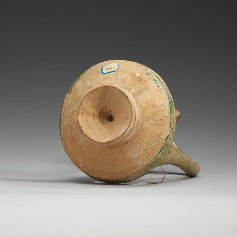 AN OIL LAMP, pottery with turquoise glaze. Height 21,5  cm. Persia (Iran), possibly Kashan 13th century.