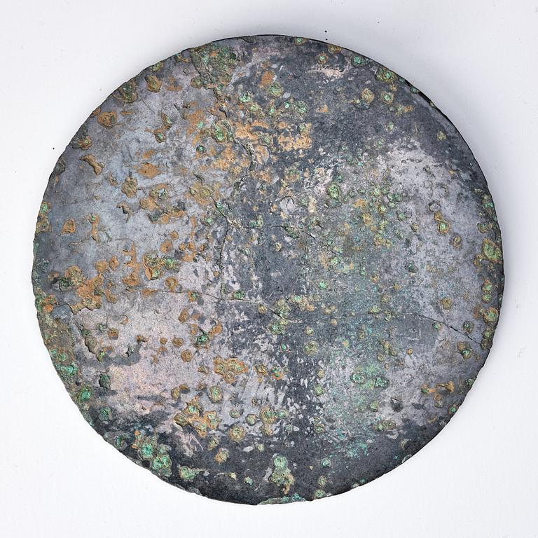 A circular bronze mirror, Han dynasty (206 B.C.-220 A.D.).